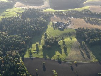 General oblique aerial view centred on the remains of the rig and furrow with the farmsteading adjacent, taken from the NNW.