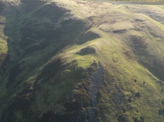 Oblique aerial view centred on the remains of the fort, taken from the NW.