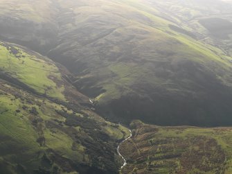 Oblique aerial view centred on the remains of the field system and farmstead, taken from the NW.