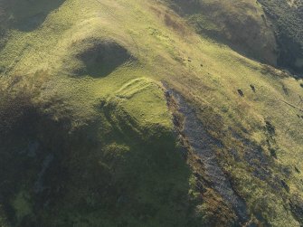 Oblique aerial view centred on the remains of the fort, taken from the NNW.