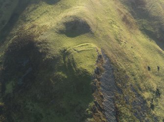 Oblique aerial view centred on the remains of the fort, taken from the NW.