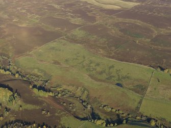 Oblique aerial view looking across the remains of the deer park boundary ditch, taken from the S.