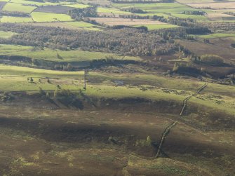 Oblique aerial view looking across the remains of the deer park boundary ditch, taken from the N.