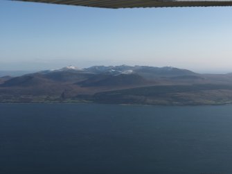 Distant general oblique aerial view looking across the snow-dusted tops of Arran, taken from the W.