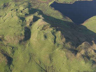 Oblique aerial view centred on the remains of the fort on Knock Scalbart, taken from the E.