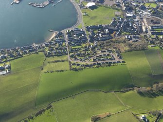 Oblique aerial view centred on the standing stone and the Dalintober area of Campbeltown, taken from the NNE.