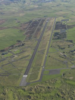 Oblique aerial view of Machrihanish Airfield looking along the runway, taken from the WNW.