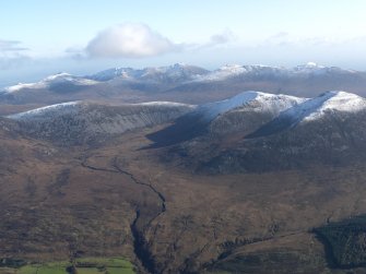 General oblique aerial view looking across the snow-dusted tops of Arran, taken from the W.
