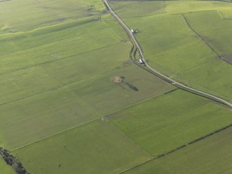 General oblique aerial view centred on the remains of the stone circle, taken from the NE.