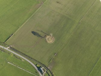 Oblique aerial view centred on the remains of the stone circle, taken from the NW.