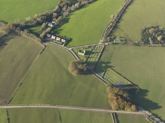 Oblique aerial view centred on the church and the remains of the earthwork, taken from the SSE.