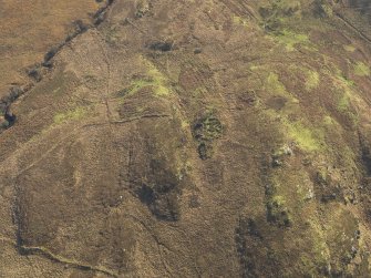 Oblique aerial view of the remains of the farmstead, field banks and rig and furrow, taken from the N.