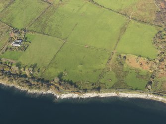 General aerial oblique view centred on the remains of the chambered cairn, taken from the SSW.