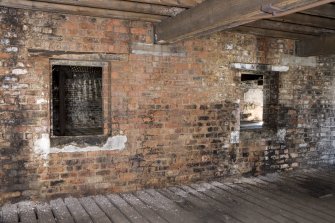 Interior view of bonded warehouse (west section) at former Rosebank Distillery. Detail of window apertures on N side of the dividing wall at first floor.