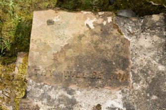 N wall. Reused stone at wallhead. Detail