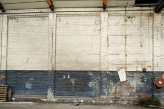 Interior, detail of N wall showing paint scheme and brick decoration.