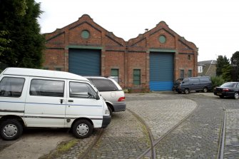 View of W end entrance with extant tram tracks iin setts in the foreground.