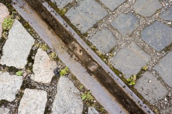 Detail of tram track, showing different directions of laid setts.