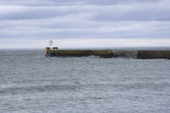 End of pier with lighthouse, view from W