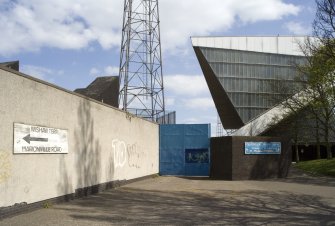 View of the grandstand at Meadowbank Stadium from the west, showing signage on the walls enclosing the stadium.