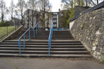 Detailed view of stairway with stone walled embankment at the northwest entrance to Meadowbank Stadium.
