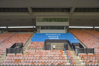 View of the grandstand seating and press box at Meadowbank Stadium.