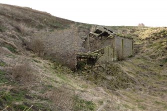 View of slope and ruined brick building below/above NW end.