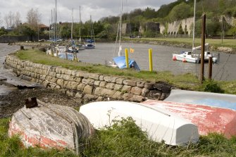 Harbour and limekilns, view from E with upturned boats in foreground