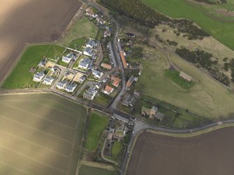 Oblique aerial view centred on the village with the parish church adjacent, taken from the SE.