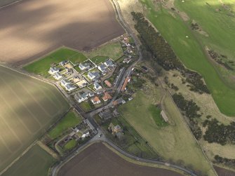 Oblique aerial view centred on the village with the parish church adjacent, taken from the ESE.