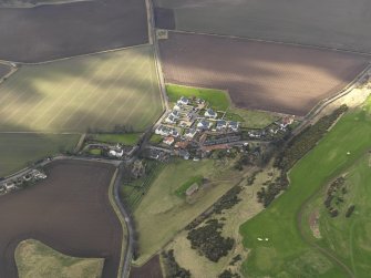 Oblique aerial view centred on the village with the parish church adjacent, taken from the ENE.