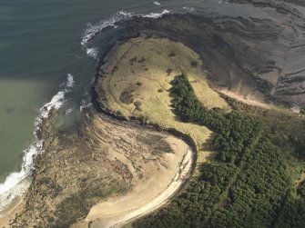 Oblique aerial view centred on the remains of the cairn with the WW II trench system adjacent, taken from the SW.