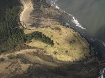 Oblique aerial view centred on the remains of the cairn with the WW II trench system adjacent, taken from the ENE.