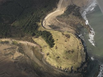 Oblique aerial view centred on the remains of the cairn with the WW II trench system adjacent, taken from the NE.