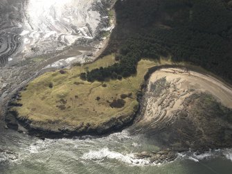 Oblique aerial view centred on the remains of the cairn with the WW II trench system adjacent, taken from the NW.