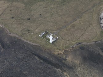 Oblique aerial view centred on the lighthouse with the keepers cottages adjacent, taken from the NE.