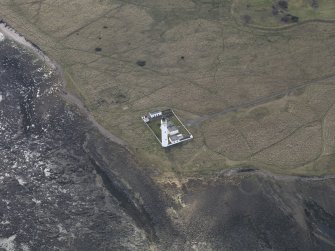 Oblique aerial view centred on the lighthouse with the keepers cottages adjacent, taken from the NNE.