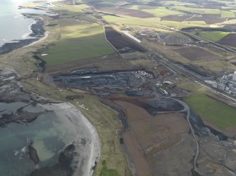 Oblique aerial view centred on the cement works with the open cast extraction adjacent, taken from the NW.