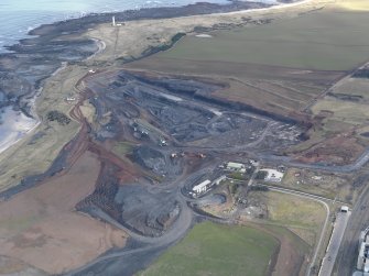 Oblique aerial view centred on the cement works with the open cast extraction adjacent, taken from the SW.