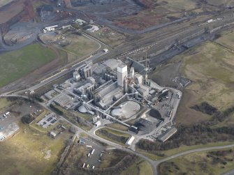 Oblique aerial view centred on the cement works with the open cast extraction adjacent, taken from the SSW.