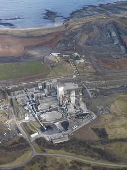 Oblique aerial view centred on the cement works with the open cast extraction adjacent, taken from the S.