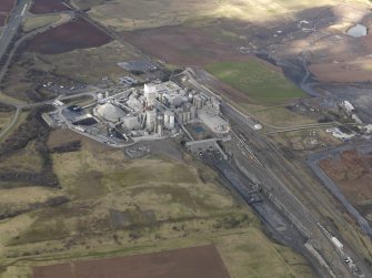 General oblique aerial view centred on the cement works with the open cast extraction adjacent, taken from the ESE.