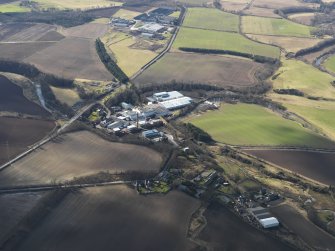 General oblique aerial view centred on the paper mill, taken from the NE.