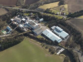 Oblique aerial view centred on the paper mill, taken from the NW.