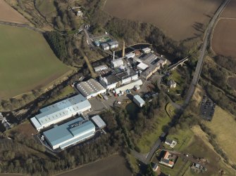 Oblique aerial view centred on the paper mill, taken from the SW.
