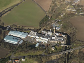 Oblique aerial view centred on the paper mill, taken from the S.