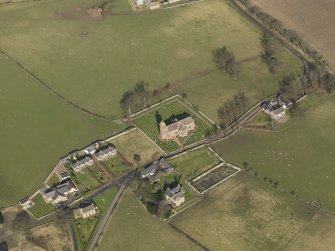 Oblique aerial view centred on the village with the church adjacent, taken from the SSW.