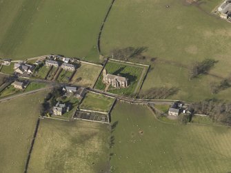 Oblique aerial view centred on the village with the church adjacent, taken from the SSE.