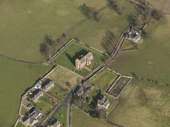 Oblique aerial view centred on the village with the church adjacent, taken from the WSW.