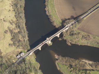 Oblique aerial view centred on the bridge with the toll house adjacent, taken from the SW.